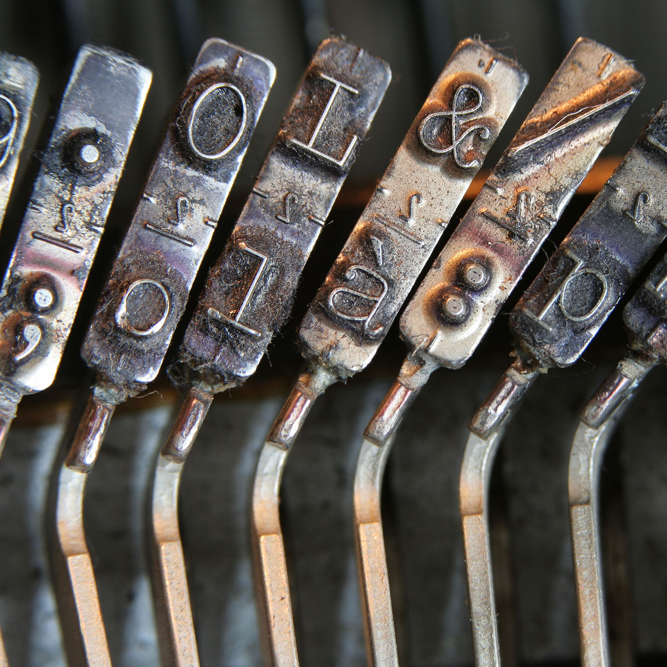 Keys on an old typewriter, some of which are punctuation marks.