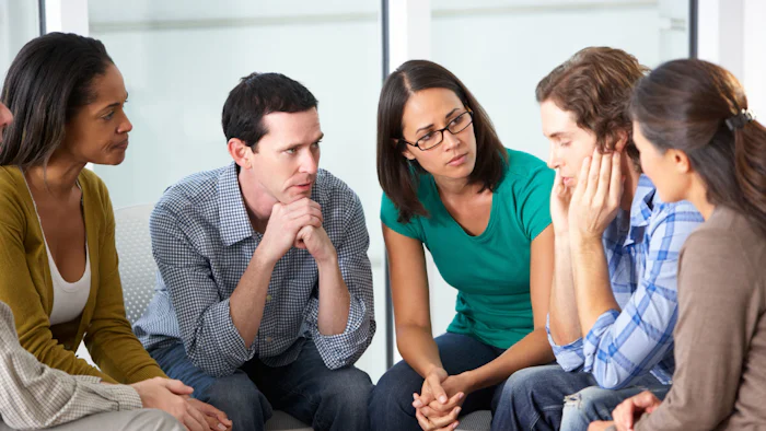 Group of colleagues showing concern for a team member.