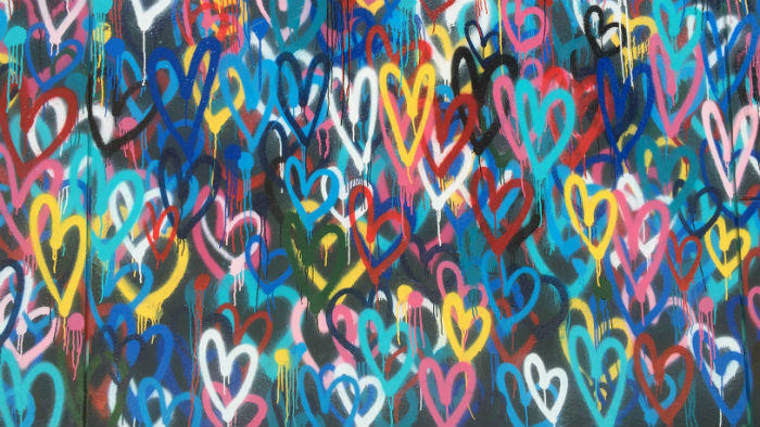 Love hearts spray painted on a wall.