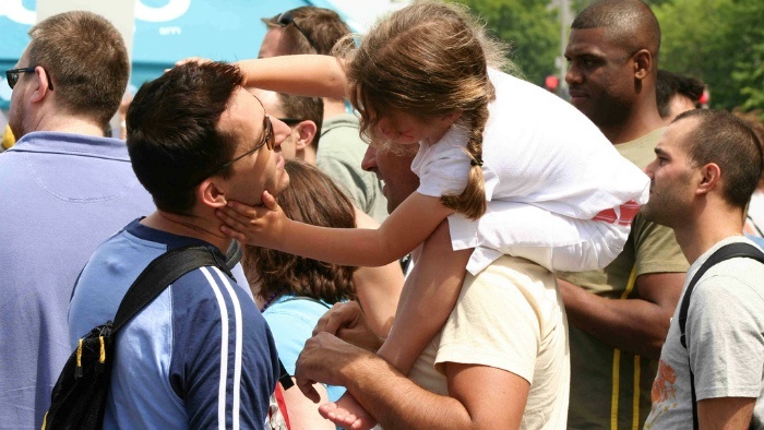 A child sitting on someone's shoulders.