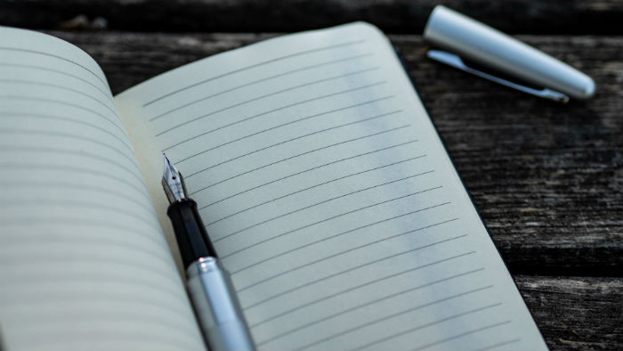 Fountain pen resting on notebook