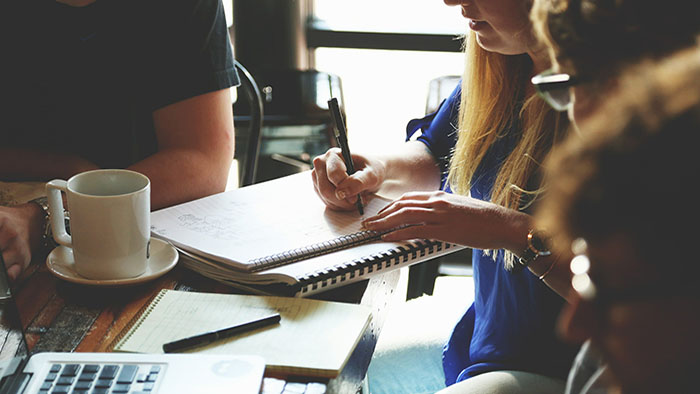 A woman making notes in her notebook. 