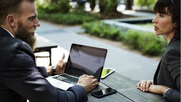 Two people sitting outside having a meeting.