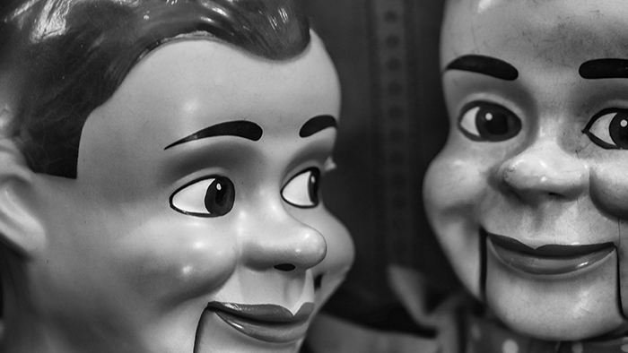 A black and white image of two ventriloquist dolls.