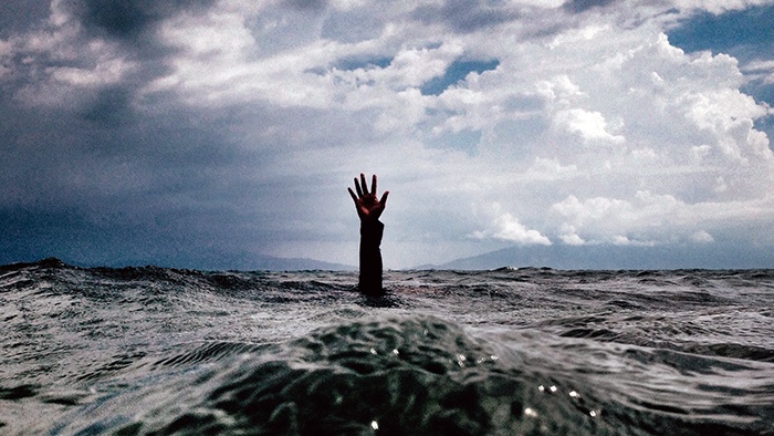 Hand reaching out of the sea