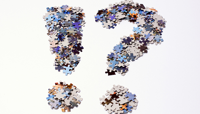 An exclamation point and question mark made from jigsaw pieces.