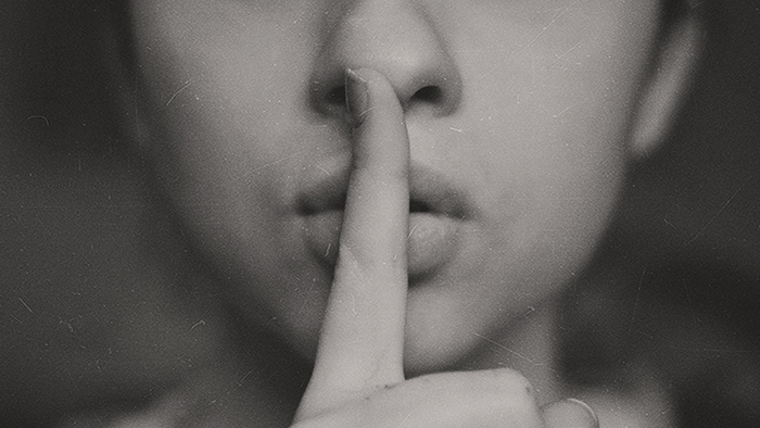 Woman with finger on lips